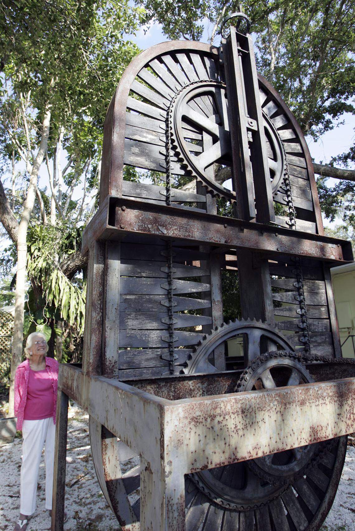 Jane Wilson stands next to a sculpture made by Robert Chambers out of parts of a bakery machine from Holsum Bakery.