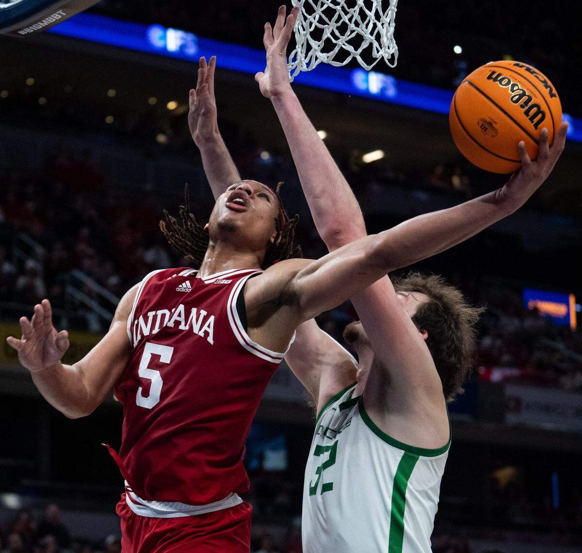 Indiana Hoosiers forward Malik Reneau (5) drives and makes the bucket Thursday, March 13, 2025, against Oregon Ducks center Nate Bittle (32) during the 2025 TIAA Big Ten Men’s Basketball Tournament at Gainbridge Fieldhouse in Indianapolis.
