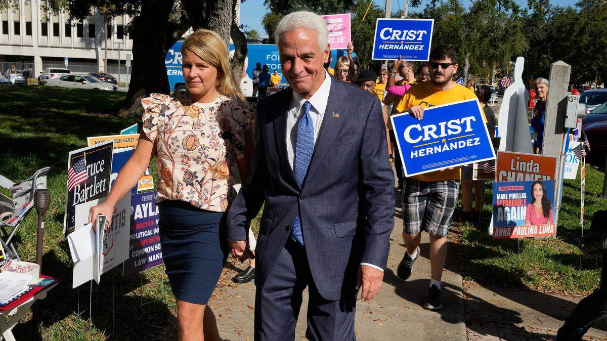 Rep. Charlie Crist, D-Fla., walks past signs on Monday, Oct. 31, 2022, in St. Petersburg, Fla. Crist is running for Florida governor against incumbent Ron DeSantis in the general election.