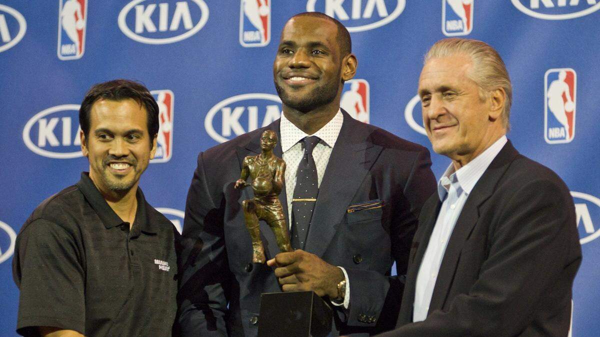 LeBron James, alongside Pat Riley (at right) and coach Erik Spoelstra, wins his 4th MVP trophy from the NBA at then-American Airlines Arena on May 5, 2013.