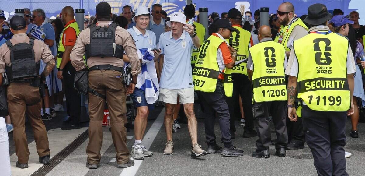 Soccer fans navigate pass security personel as they enter the gates for Uruguay against Saudi Arabia FIFA World Cup opening match at Miami Stadium on Monday, June 15, 2026.