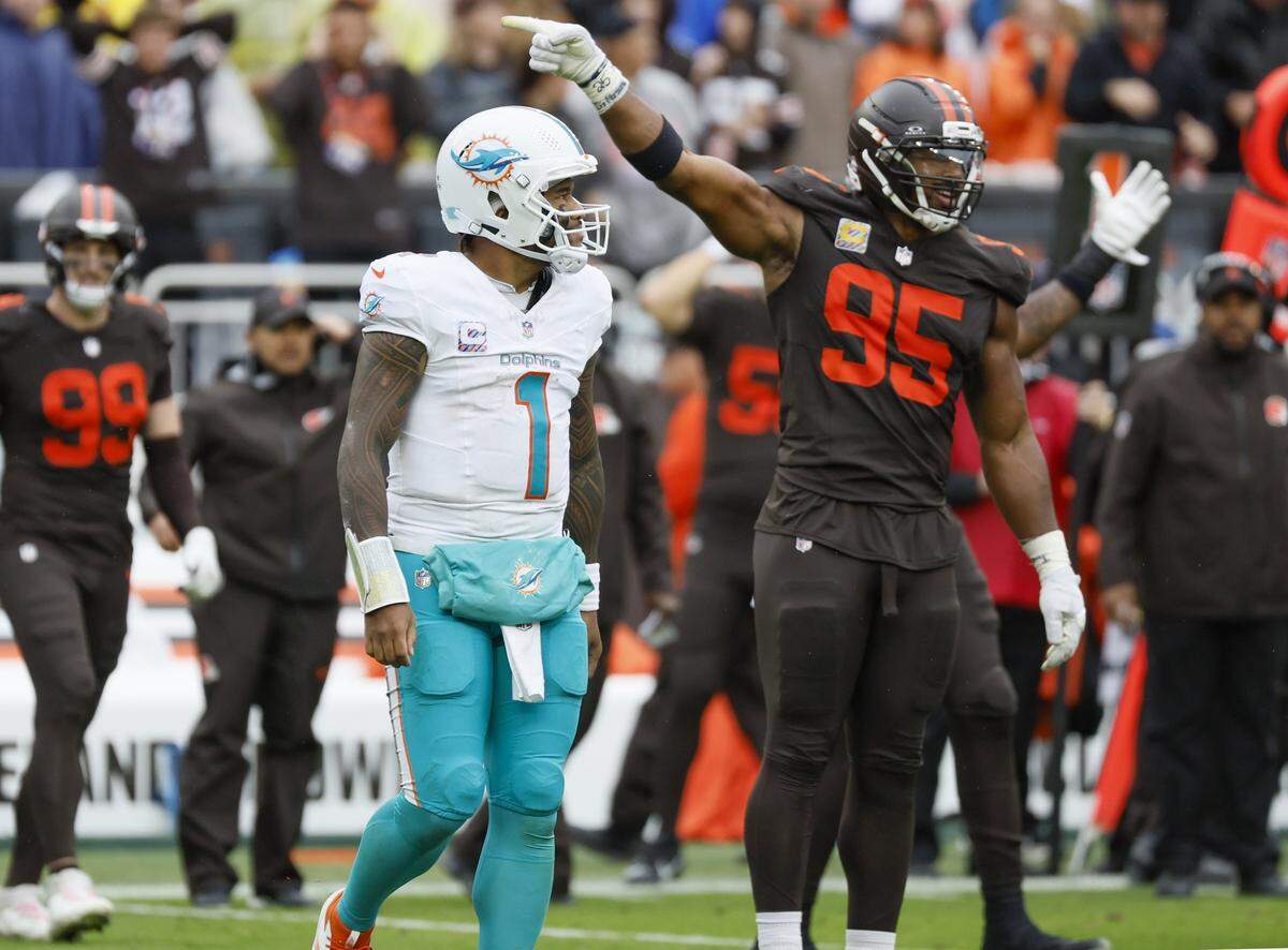 Cleveland Browns defensive end Myles Garrett (95) signals that the Browns have possession of the ball after Miami Dolphins quarterback Tua Tagovailoa (1) turnover during the second half of an NFL football game at Huntington Bank Field in Cleveland, Ohio, on Sunday, October 19, 2025.