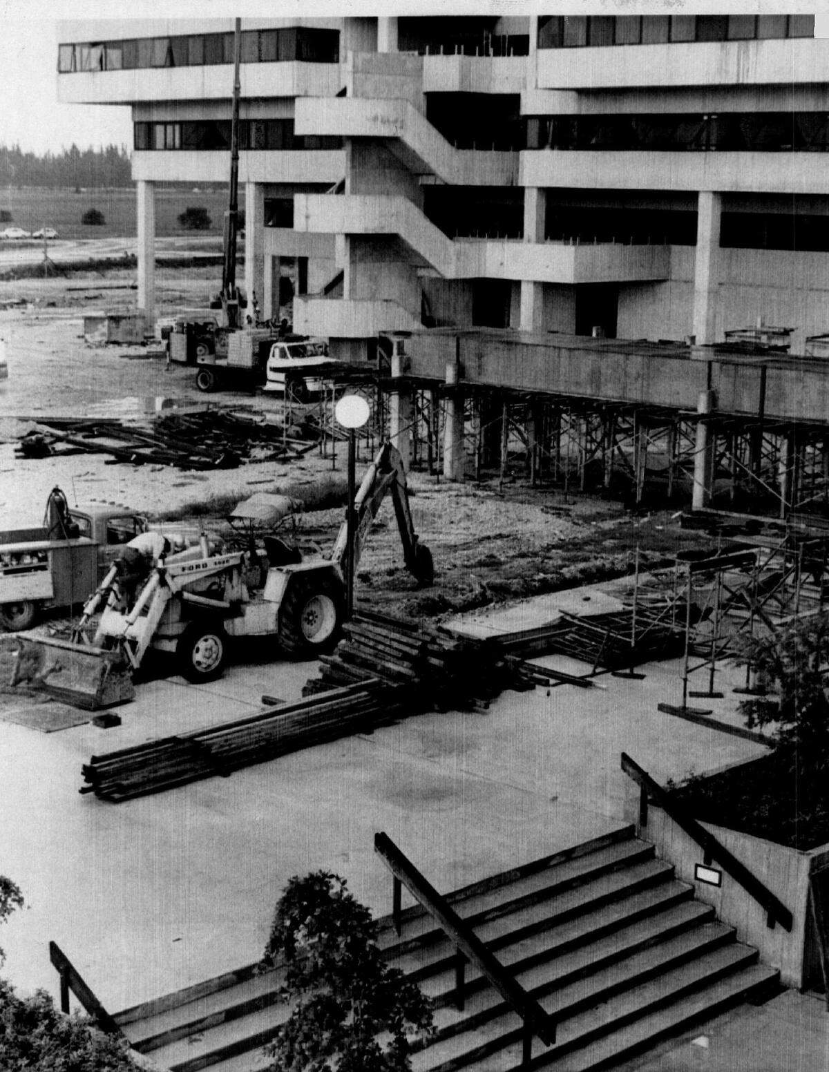 FIU resounds with the pounding of hammers and the roar of earth movers as construction crews working on campus mingle with students working on degrees. 1972.