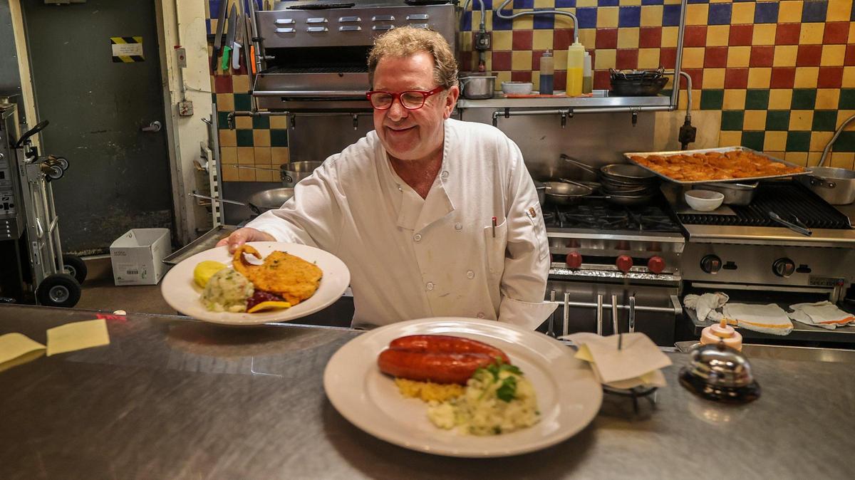 Fritz & Franz Bierhaus owner Harald Neuweg brings some dishes out of the kitchen of his iconic restaurant in December 2023.