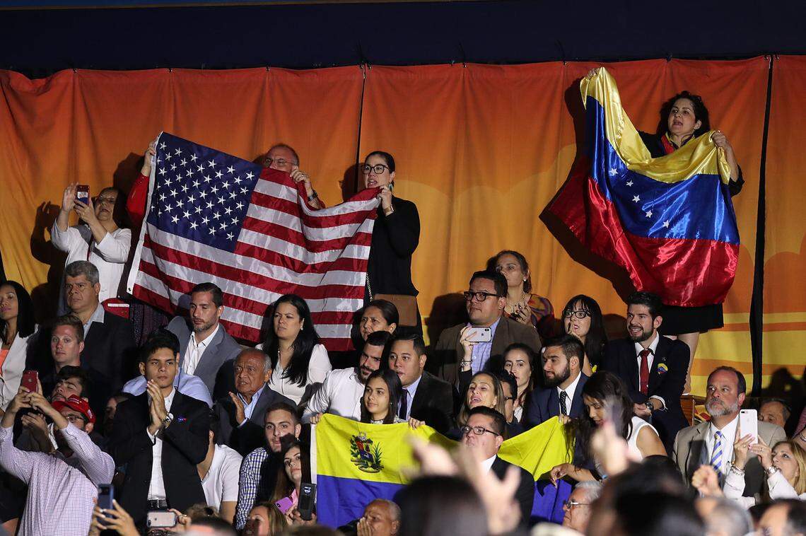 Supporters listen as President Trump speaks during a 2019 rally at Florida International University in Miami, where he addressed the Venezuelan crisis. Despite this, he never approved TPS for Venezuelan exiles, and now, in his second term, the rollback of an 18-month TPS extension has left them facing an uncertain future.
