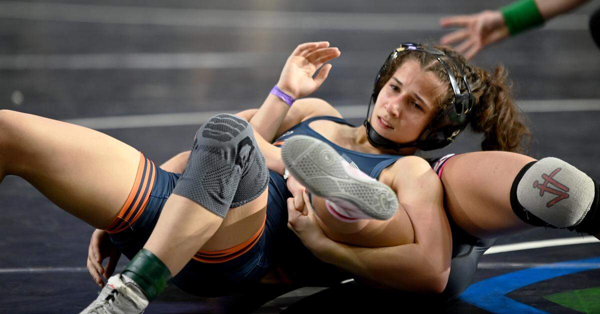 Mater Lakes freshman Paola Perez hugs her coach after winning the girls 100-pound wrestling state title on Saturday at Silver Spurs Arena in Kissimmee.
