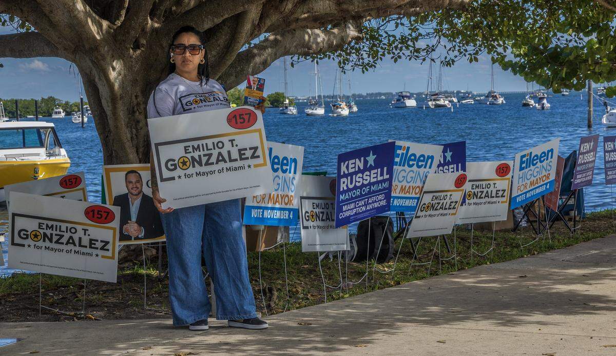 Joannia Estrada, a volunteer for the mayoral candidate Emilio Gonzalez campaigns outside of the City of Miami city hall voting poll location, during the early voting period for the November 4, 2025 City of Miami general municipal and special elections, on Saturday November 01, 2025.