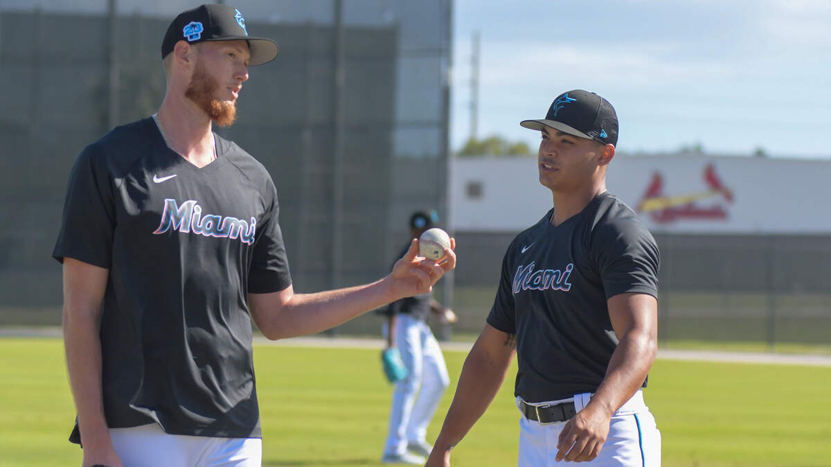 Miami Marlins left-handed pitchers A.J. Puk (left) and Jesus Luzardo talk during a workout at the Roger Dean Chevrolet Stadium complex in Jupiter, Florida, on Wednesday, Feb. 15, 2023.