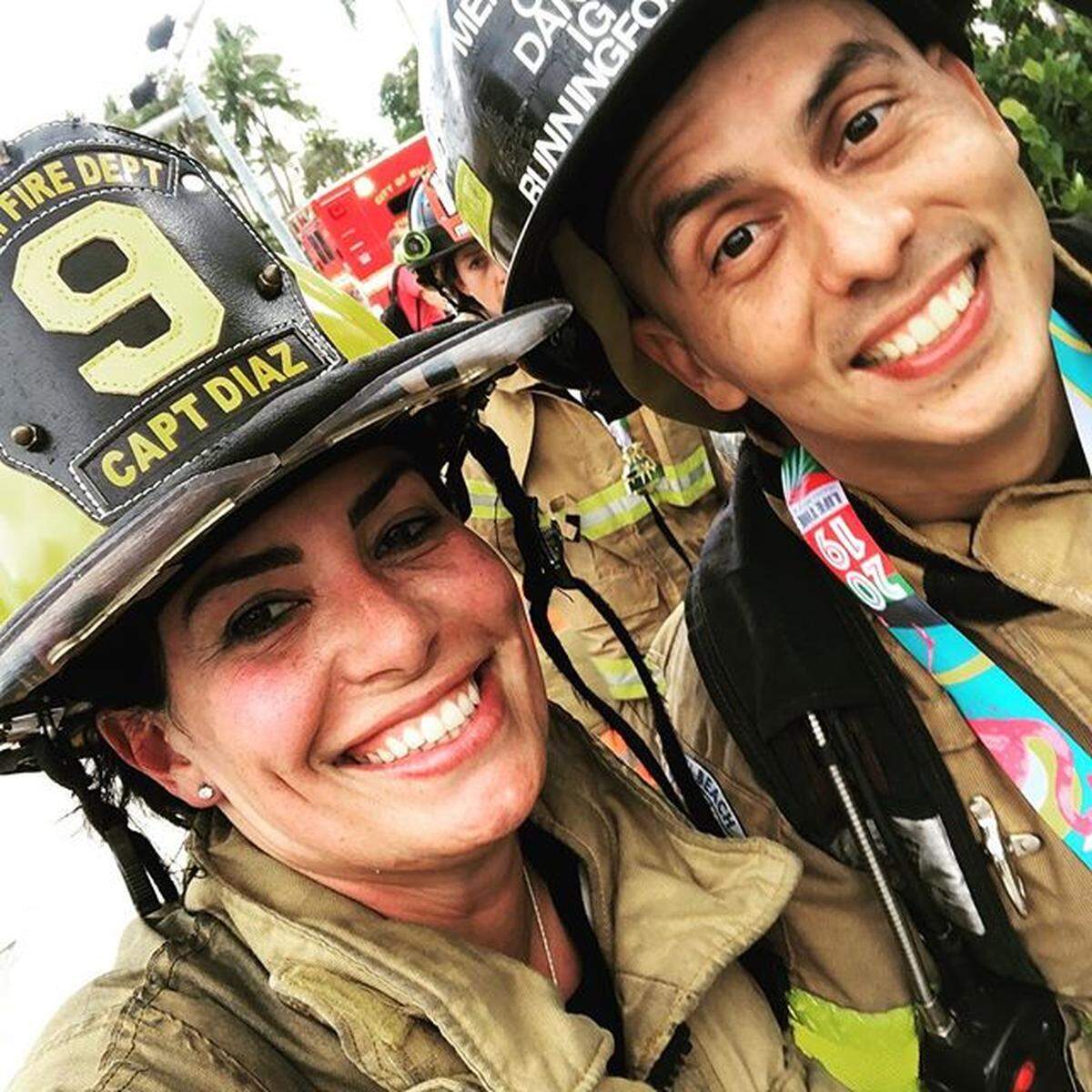 City of Miami fire Capt. Yami Diaz and Miami Beach firefighter Claudio Navas after finishing the 2019 Miami Half Marathon in full gear as part of the Never Walk Alone team.