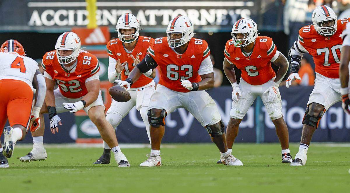 Miami Hurricanes quarterback Carson Beck (11) takes a snap as the offense line blocks against the Syracuse Orange in the first half of an NCAA football game at Hard Rock Stadium in Miami Gardens, Florida on Saturday, November 8, 2025. 