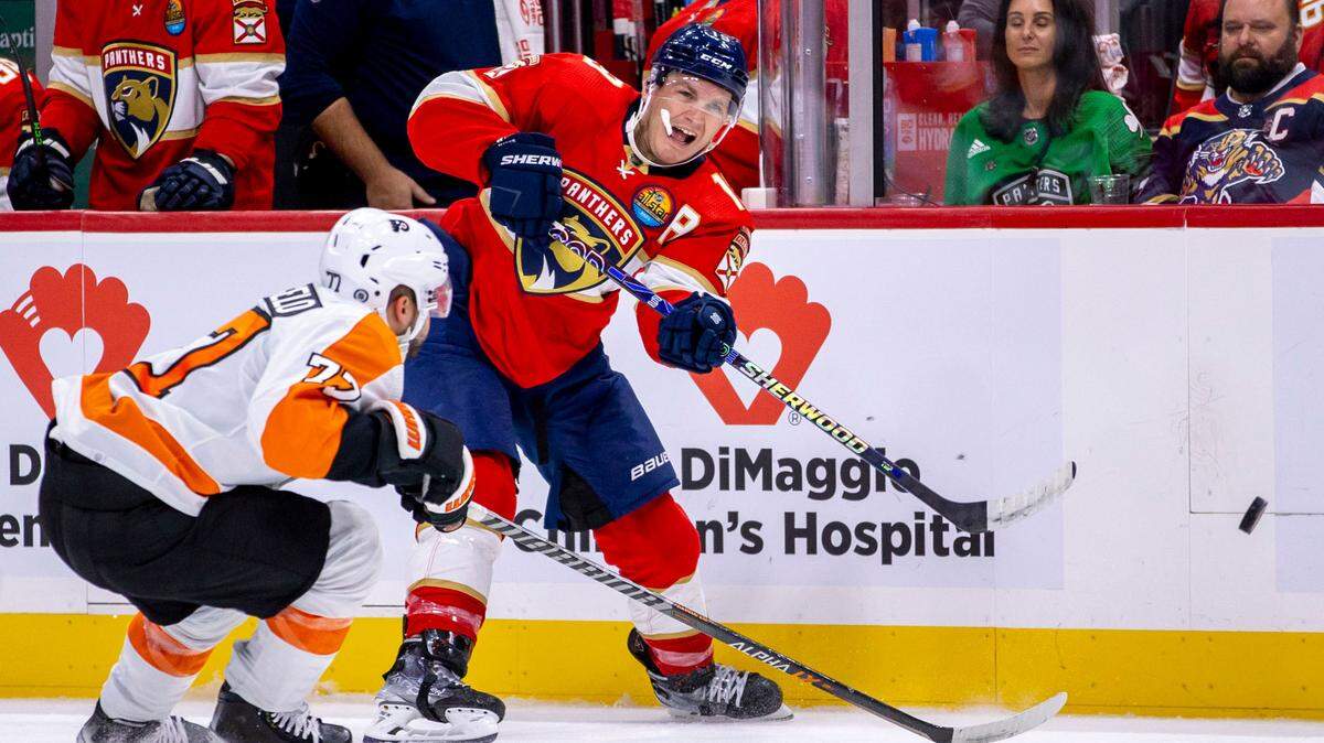 Florida Panthers left wing Matthew Tkachuk (19) shoots on goal while guarded by Philadelphia Flyers defender Tony DeAngelo (77) during the second period of an NHL game at FLA Live Arena in Sunrise, Florida, on Wednesday, October 19, 2022.