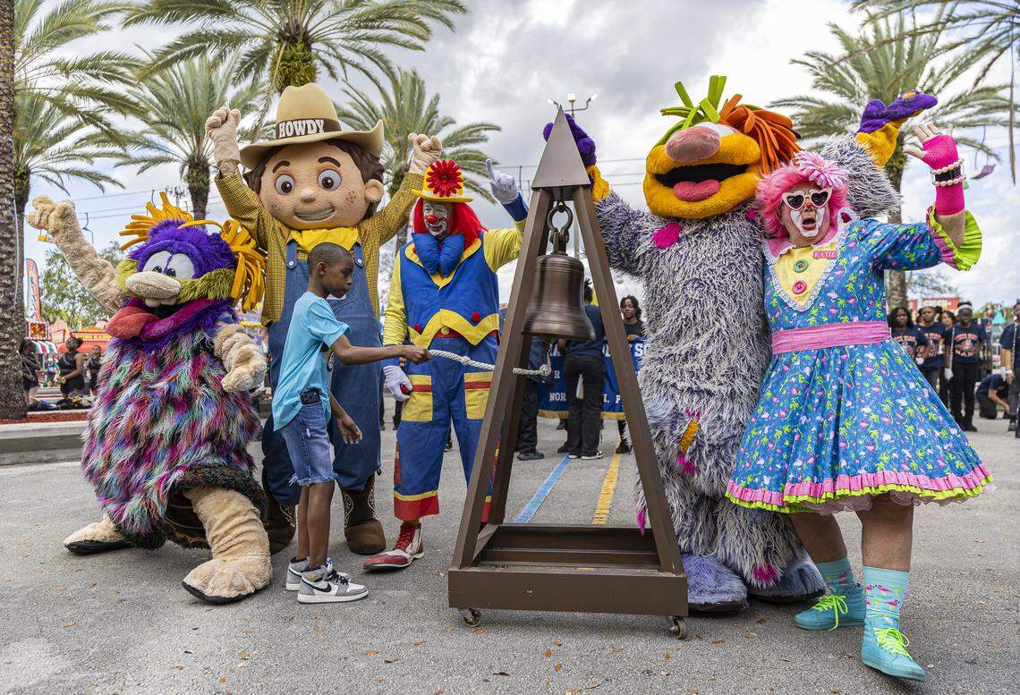 Landon Rogers, 13, surrounded by mascots, rings a bell to celebrate the start of the 74th annual Miami-Dade County Youth Fair on Thursday, March 12, 2026, in Miami, Fla.