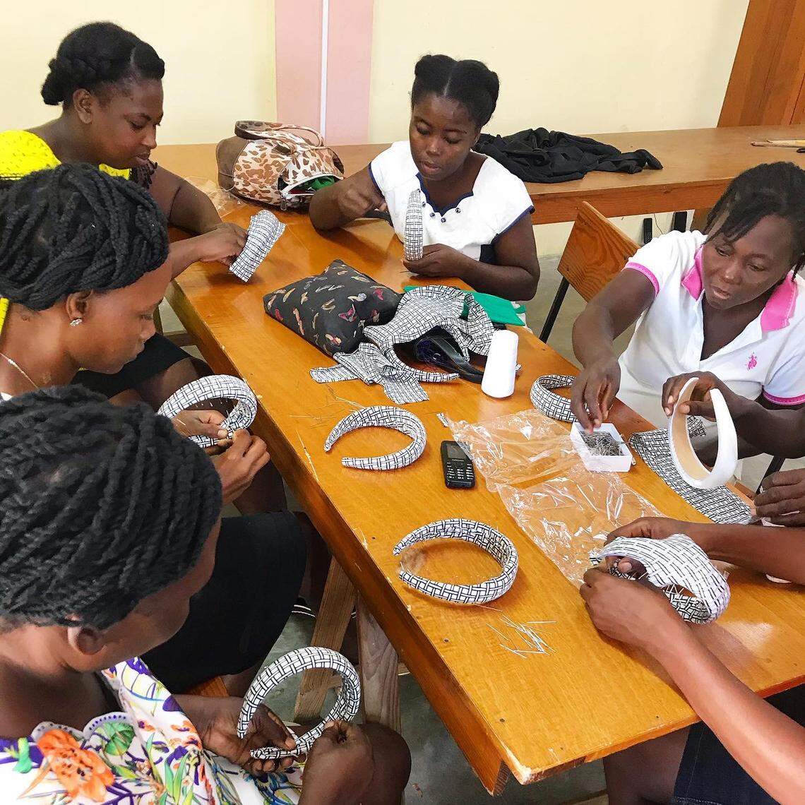 A group of female seamstresses in central Haiti making headbands for the Bien Abyé, Haitian-Creole for Well-Dressed, line of colorful silk printed face masks, headbands and scrunchies. Designed by Haitian-designer Dayanne Danier, the line is now being sold in select Nordstrom stores across the U.S. and online.