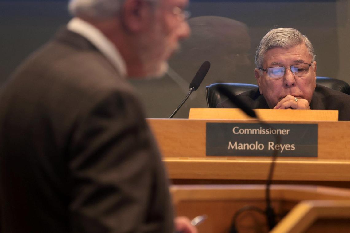 Commissioner Manolo Reyes listens to Holland & Knight attorney and consultant Miguel De Grandy as he presented the preliminary redistricting plan during a special commission meeting at City Hall on Monday, Feb. 7, 2022.