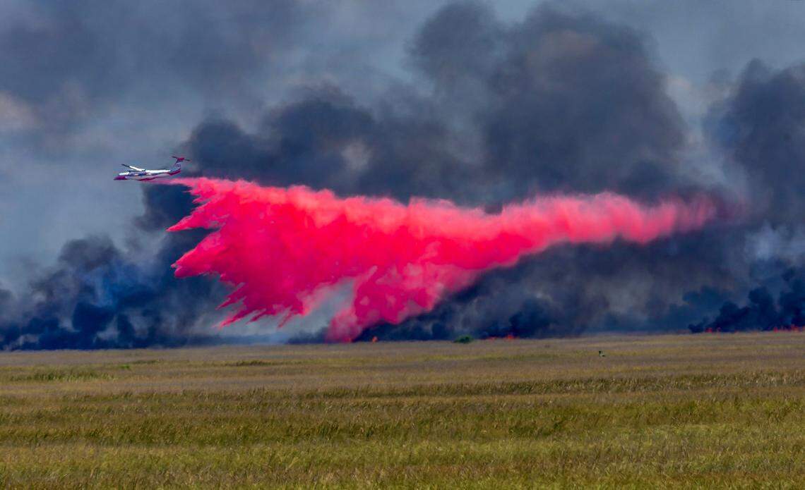 A plane drops fire retardant on a large wildfire on the south side of Tamiami Trail on Tuesday, April 28, 2026.