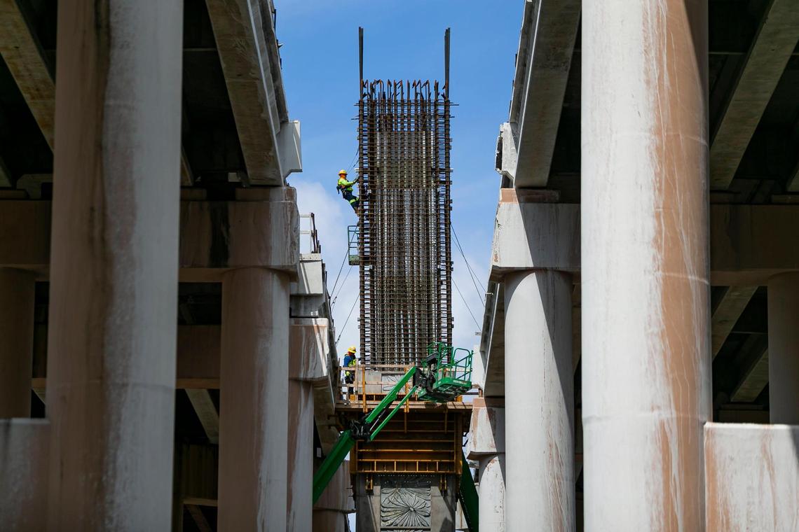 Employees work on a pier expansion for the SR-836 as part of the construction project taking place in Miami on Tuesday, June 8, 2021.