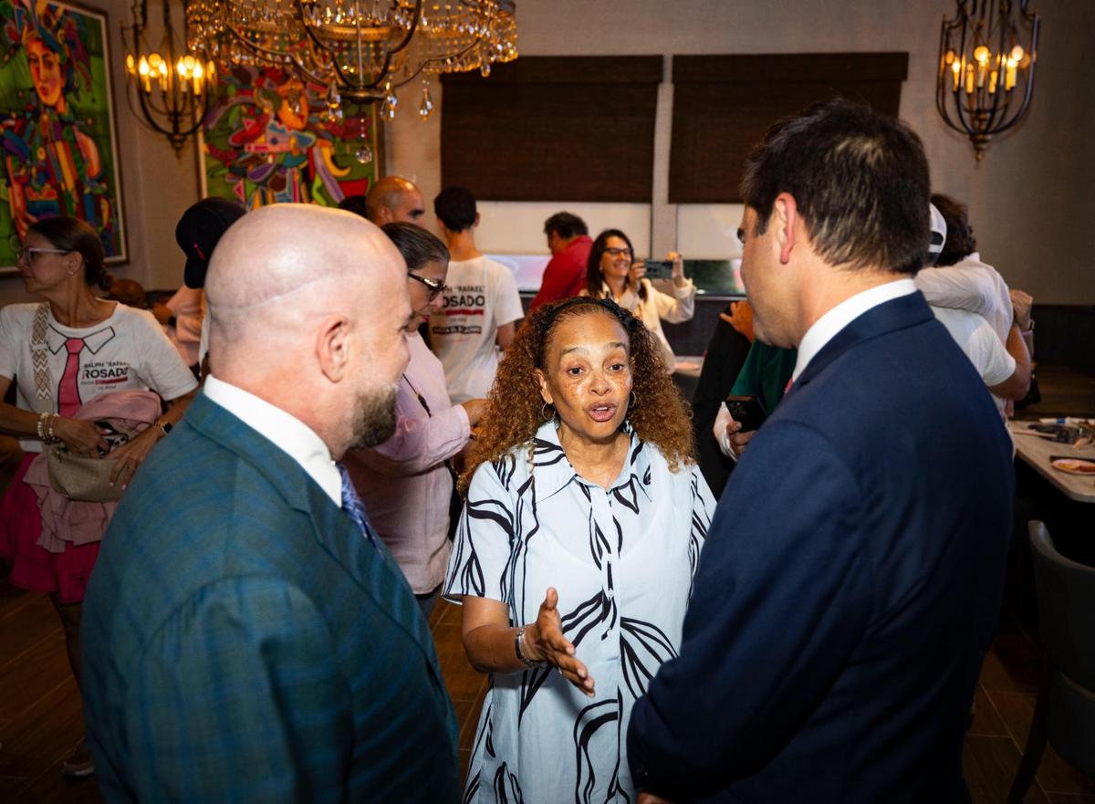 Miami City Commission Chairwoman Christine King, center, and Commissioner Damian Pardo, left, speak to Ralph Rosado during his watch party on Tuesday, June 3, 2025, at El Atlacatl restaurant in Miami.
