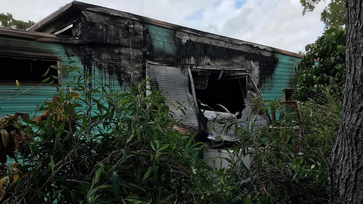 A mobile home on Avenue B smolders after a fire Wednesday, Jan. 23. A dog was found dead inside.