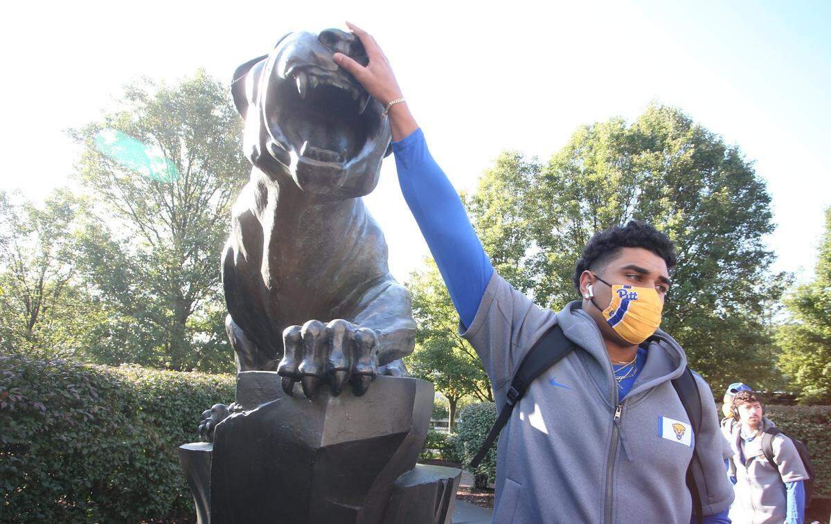 Oct 3, 2020; Pittsburgh, Pennsylvania, USA; Pittsburgh Panthers defensive lineman Rashad Weaver (17) touches the Panther statue outside of the stadium for luck before the game against the North Carolina State Wolfpack at Heinz Field. Mandatory Credit: Charles LeClaire-USA TODAY Sports