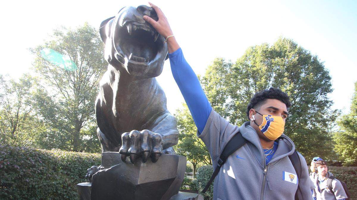 Oct 3, 2020; Pittsburgh, Pennsylvania, USA; Pittsburgh Panthers defensive lineman Rashad Weaver (17) touches the Panther statue outside of the stadium for luck before the game against the North Carolina State Wolfpack at Heinz Field. Mandatory Credit: Charles LeClaire-USA TODAY Sports