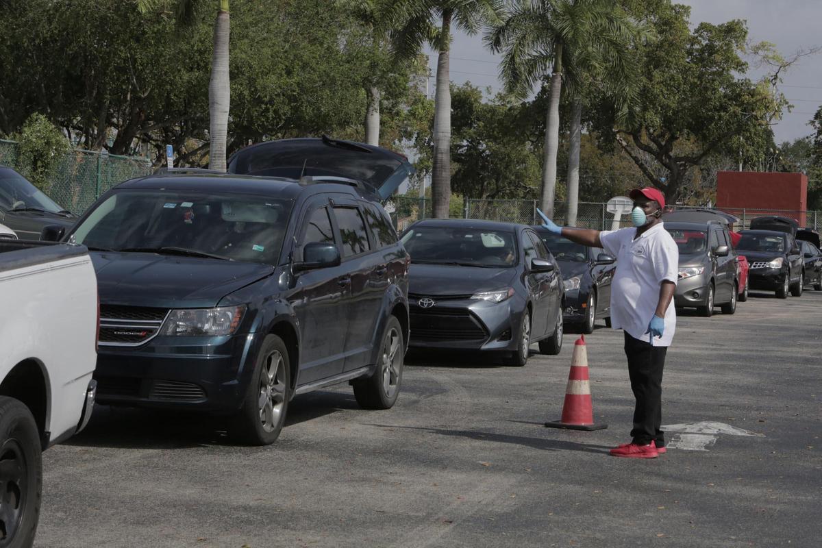 Terry Elliott Sr., founder of Elliott’s Ark of the City, directs traffic during the food drive.