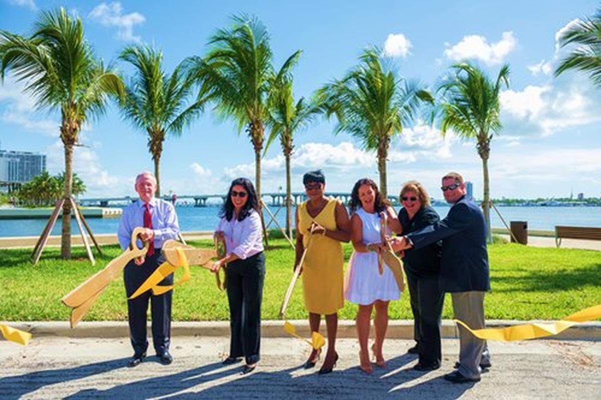 Miami-Dade officials, including cultural chief Michael Spring, left, Parks Director Maria Nardi, second from left, and County Commissioner Audrey Edmonson, third from left, take part in a ribbon-cutting ceremony last July celebrating the installation of more grass and trees on “Parcel B,” a county-owned parcel on the Miami waterfront that had been slated for a museum honoring Cuban exiles.