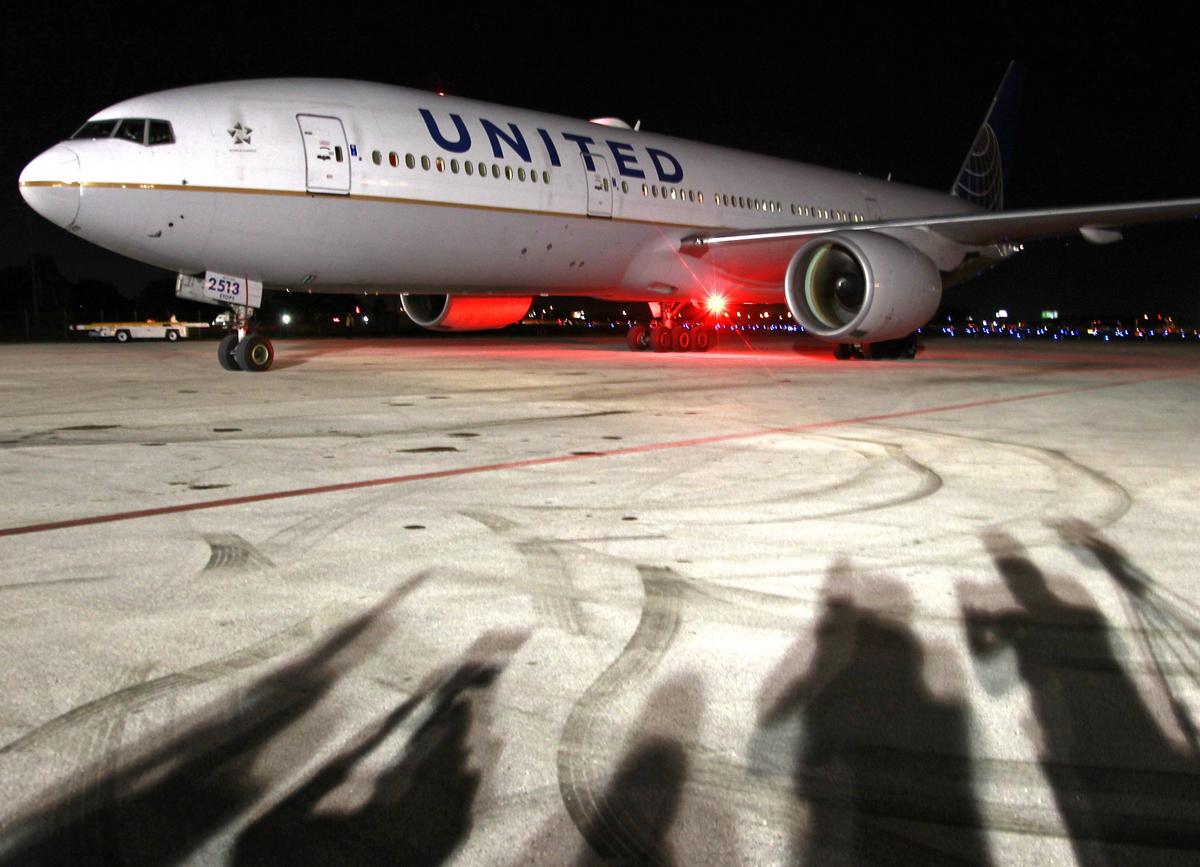 On Sunday, December 23, 2018, a charter United jet taxis on the tarmac at Signature Flight Support as members and staff of the University of Oklahoma football team prepare to disembark during their arrival at Signature Flight Support to play against Alabama at Hard Rock Stadium in the Capital One Orange Bowl, the 2018 College Football Playoff Semifinals, on December 29, 2018.