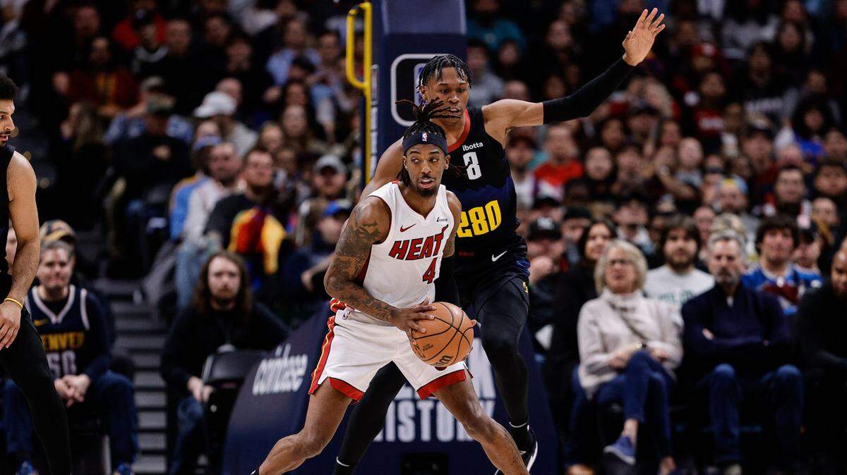 El jugador del Heat Delon Wright (4) trata de pasar la marca de Peyton Watson, de los Nuggets, en el partido celebrado el 29 de febrero de 2024 en Denver.