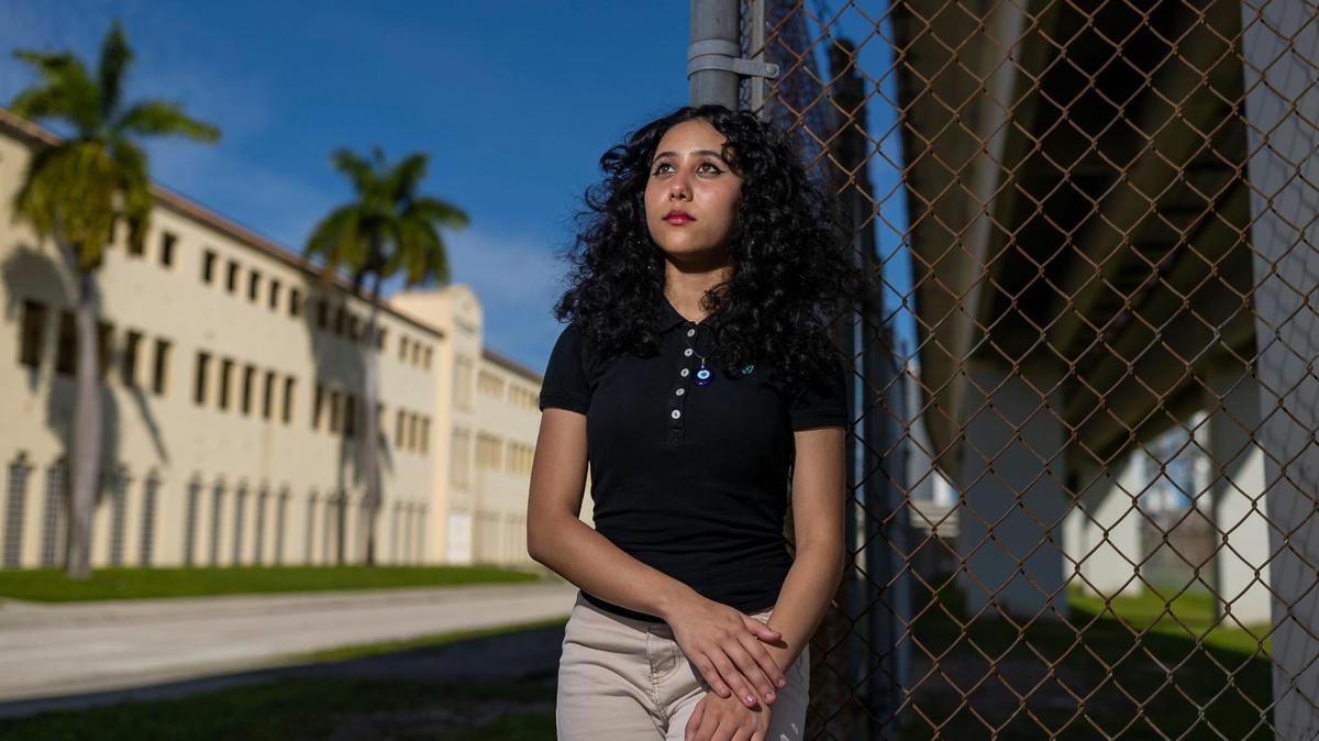 Allison, 15, an 11th-grader at Booker T. Washington Senior High in Miami, is photographed outside of her school on Tuesday, Oct. 11, 2022. She has struggled with mental health issues since moving to Miami from Costa Rica during the pandemic and straddled caring for her younger siblings while her parents worked with remote learning.