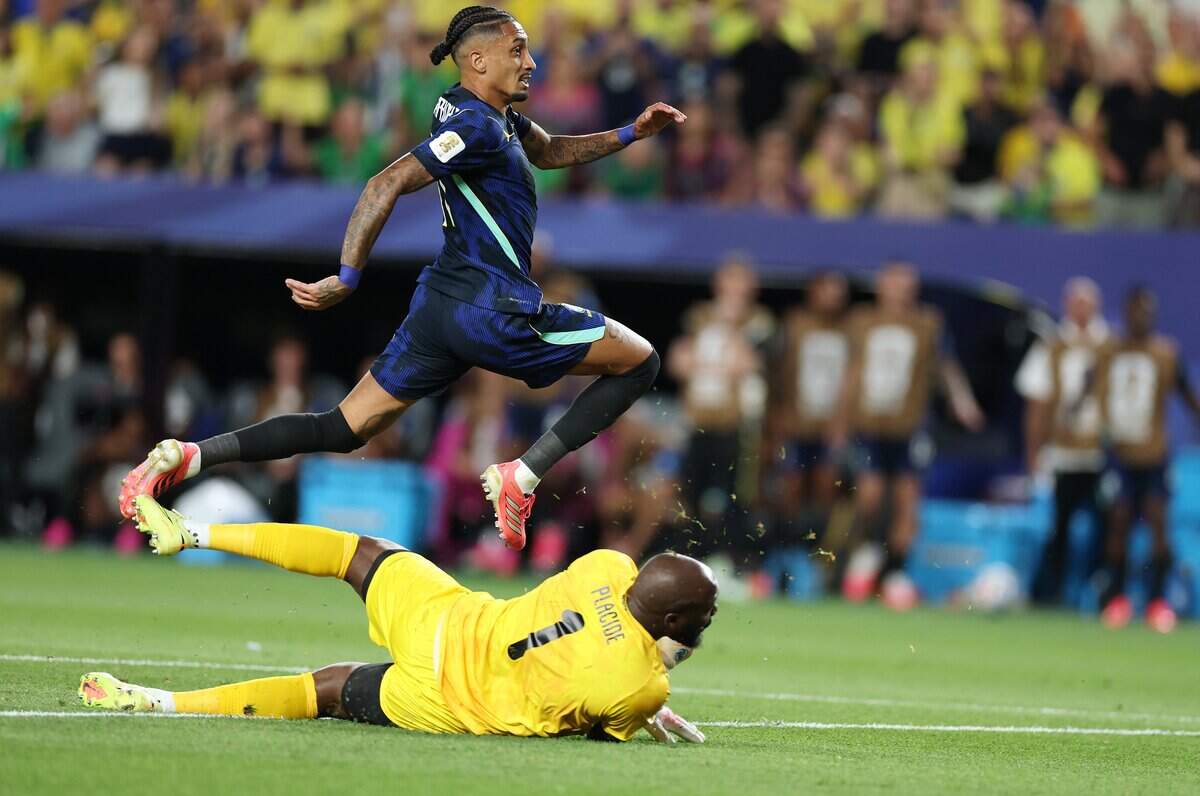 PHILADELPHIA, PENNSYLVANIA - JUNE 19:  Raphinha #11 of Brazil shoots against Johnny Placide #1 of Haiti during the FIFA World Cup 2026 Group C match between Brazil and Haiti at Philadelphia Stadium on June 19, 2026 in Philadelphia, Pennsylvania. (Photo by Al Bello/Getty Images)