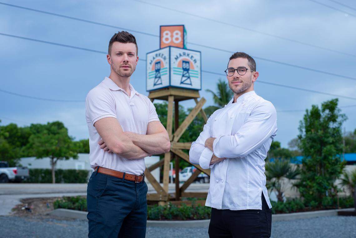 Charles Galvin and Chef Zack Sklar, both owners representatives at Marker 88 in Islamorada in front of the refurbished sign.