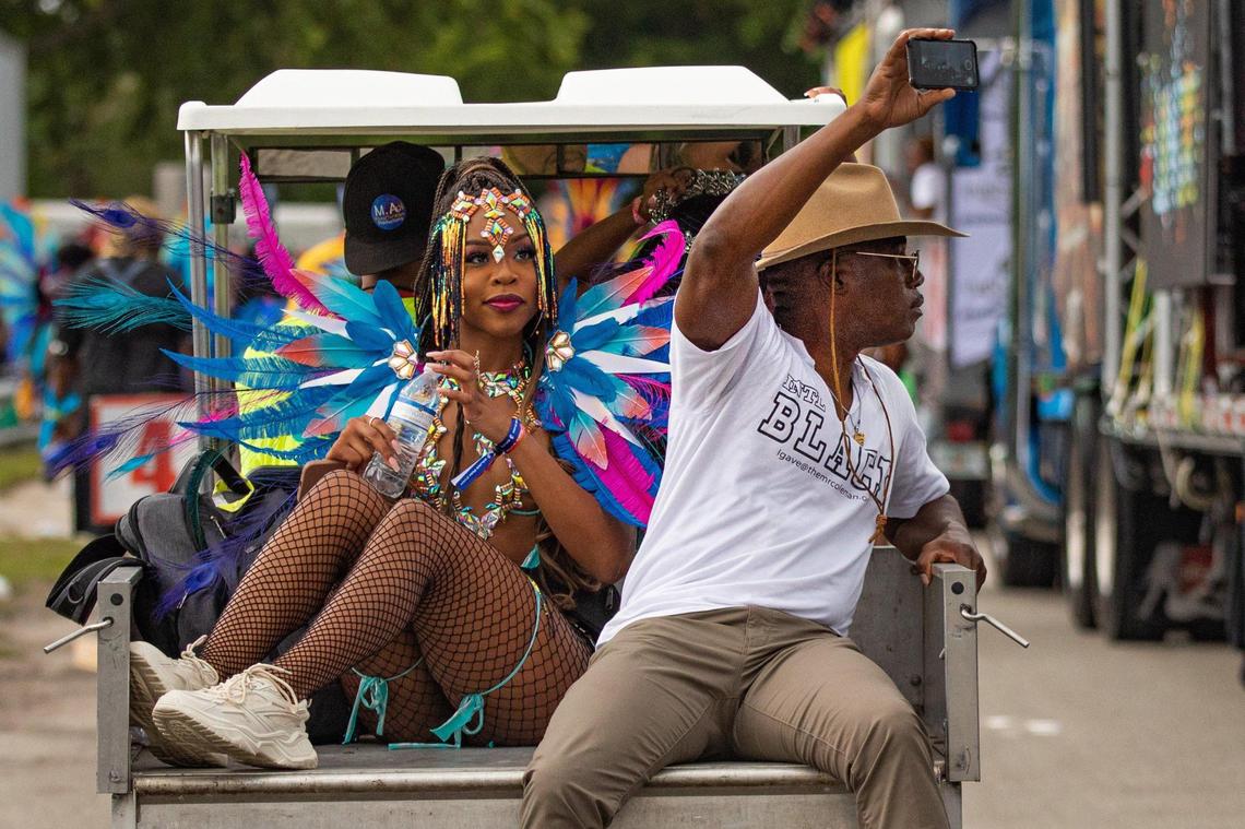 A performer rides on the back of a golf cart during Miami Carnival at the Miami-Dade County Fair Expo in Miami, Florida on Sunday, October 9, 2022.