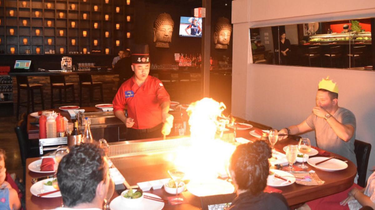 A chef prepares food for guests at Red Door Asian Bistro in Fort Lauderdale. The owners said in a federal lawsuit that opening the restaurant became a nightmare in 2018 when a city inspector made repeated racist remarks and unfairly cited them for code violations.