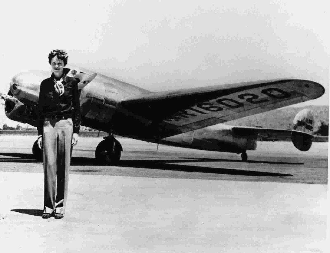 Amelia Earhart stands in front of her Lockheed 10-E Electra plane. She along with her navigator disappeared trying to circumnavigate the globe in 1937.