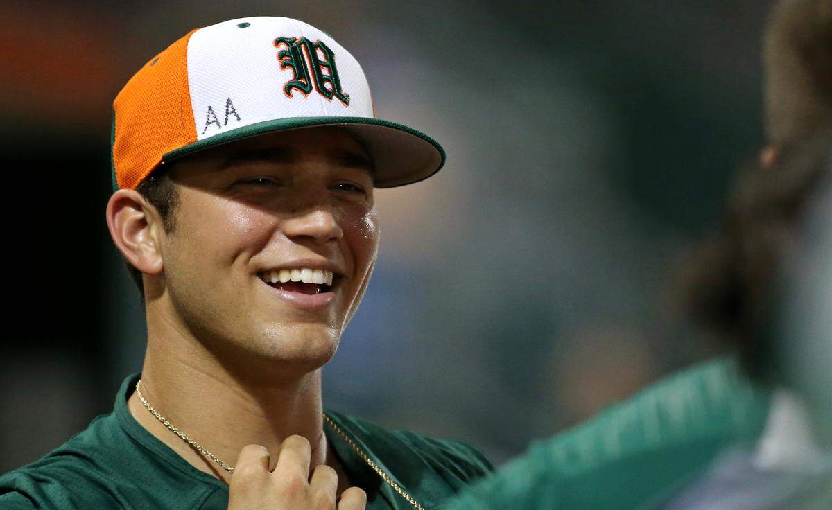 Miami Hurricanes pitcher Slade Cecconi (21) smiles at the dugout during the seventh inning of a NCAA baseball game against the Florida Atlantic University Owls at Alex Rodriguez Park at Mark Light Field on Wednesday, February 20, 2019 in Coral Gables.