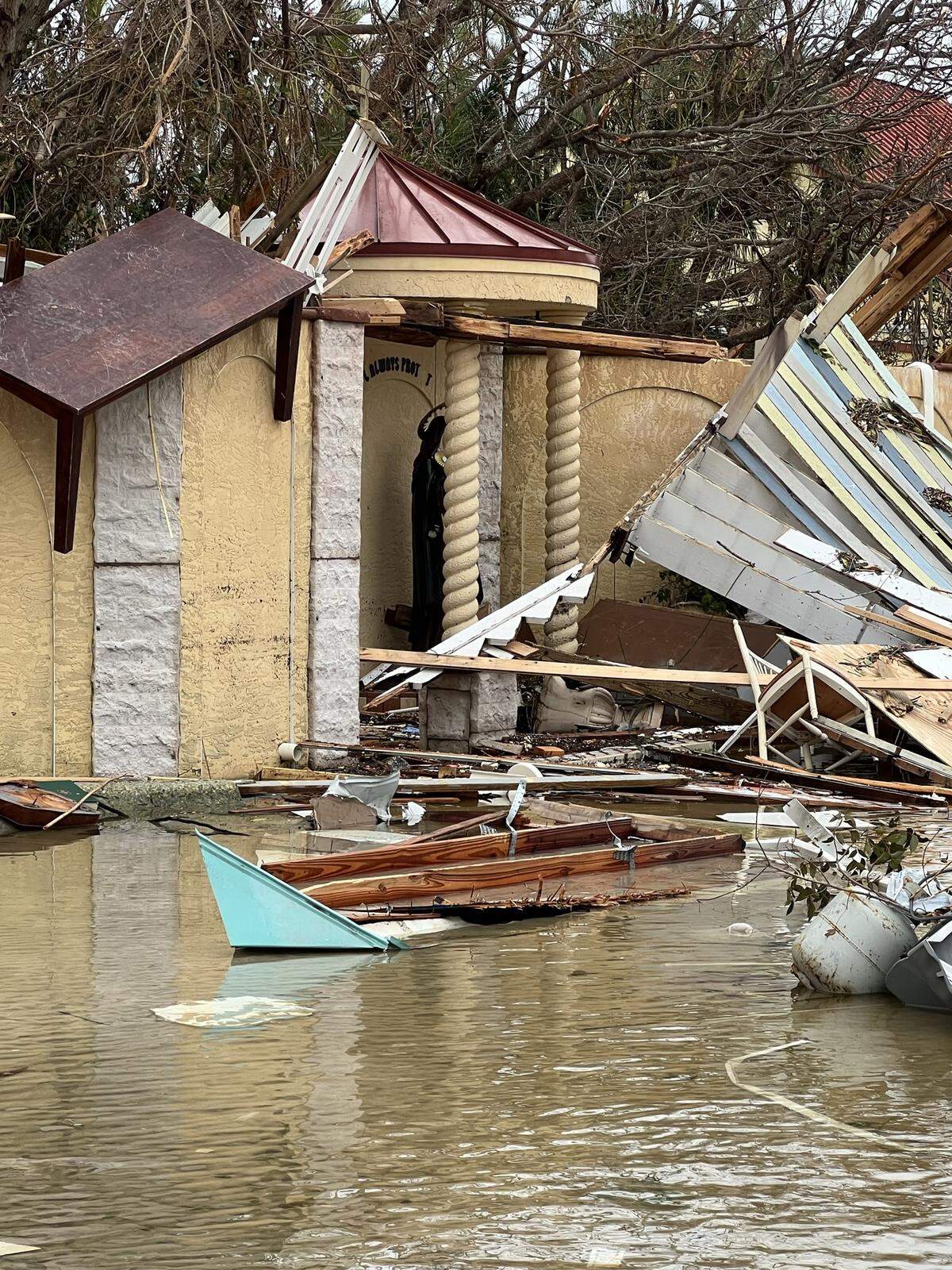 Debris from destroyed homes were pushed by Hurricane Ian storm surge onto the property of Ascension Parish and San Damiano Monastery on Fort Myers Beach as seen on Sept. 29, 2022.