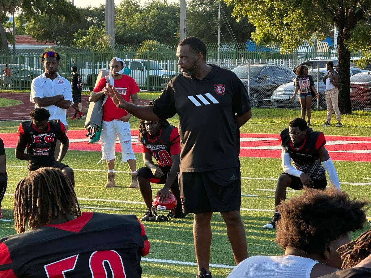 Miami Edison football coach Luther Campbell speaks to his team after they defeated North Miami 21-19 on Thursday afternoon at their school’s home field.