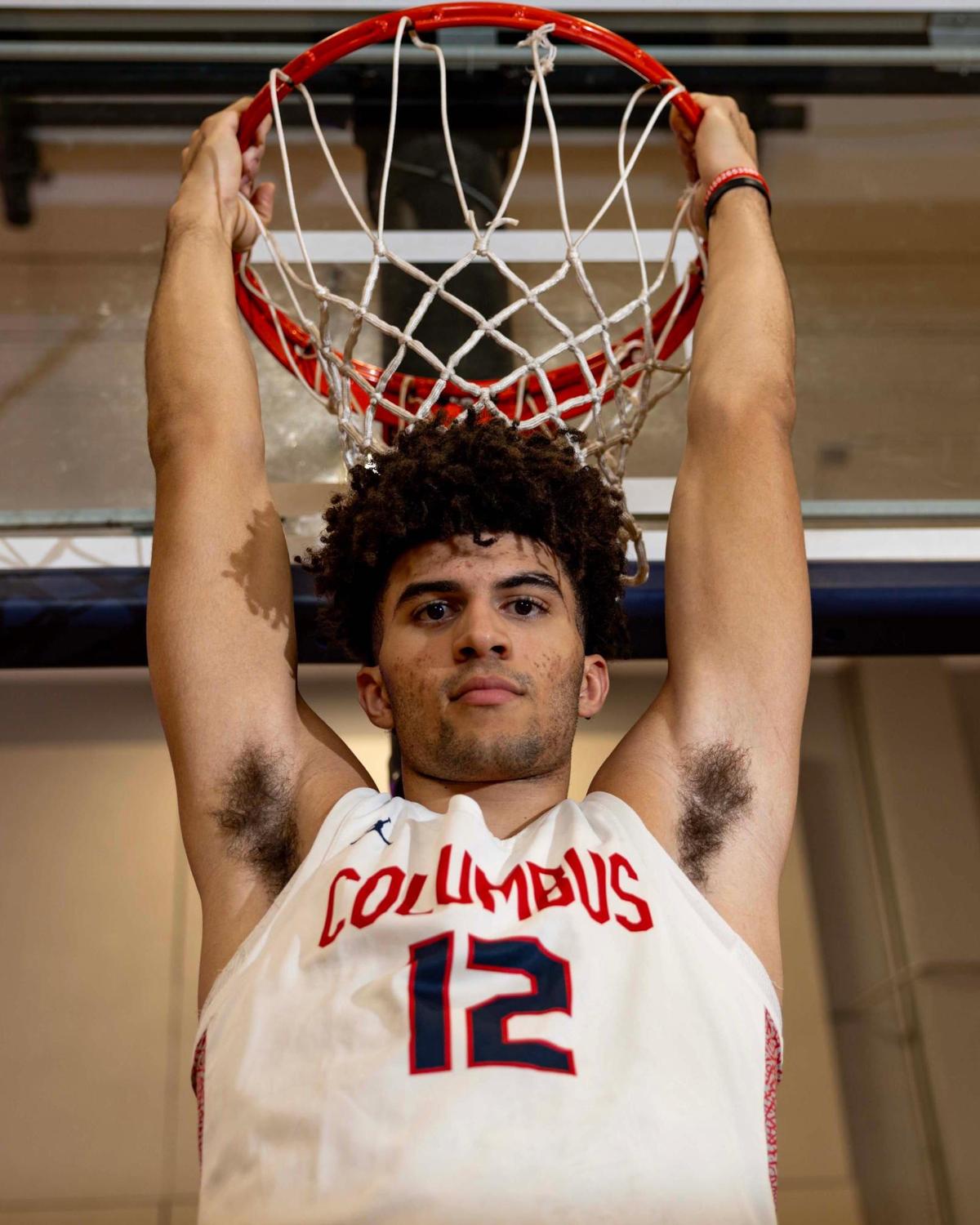 Columbus basketball player Cameron Boozer (12) hangs from the rim for a portrait at Christopher Columbus High School on Thursday, March 20, 2025, in Miami, Florida.