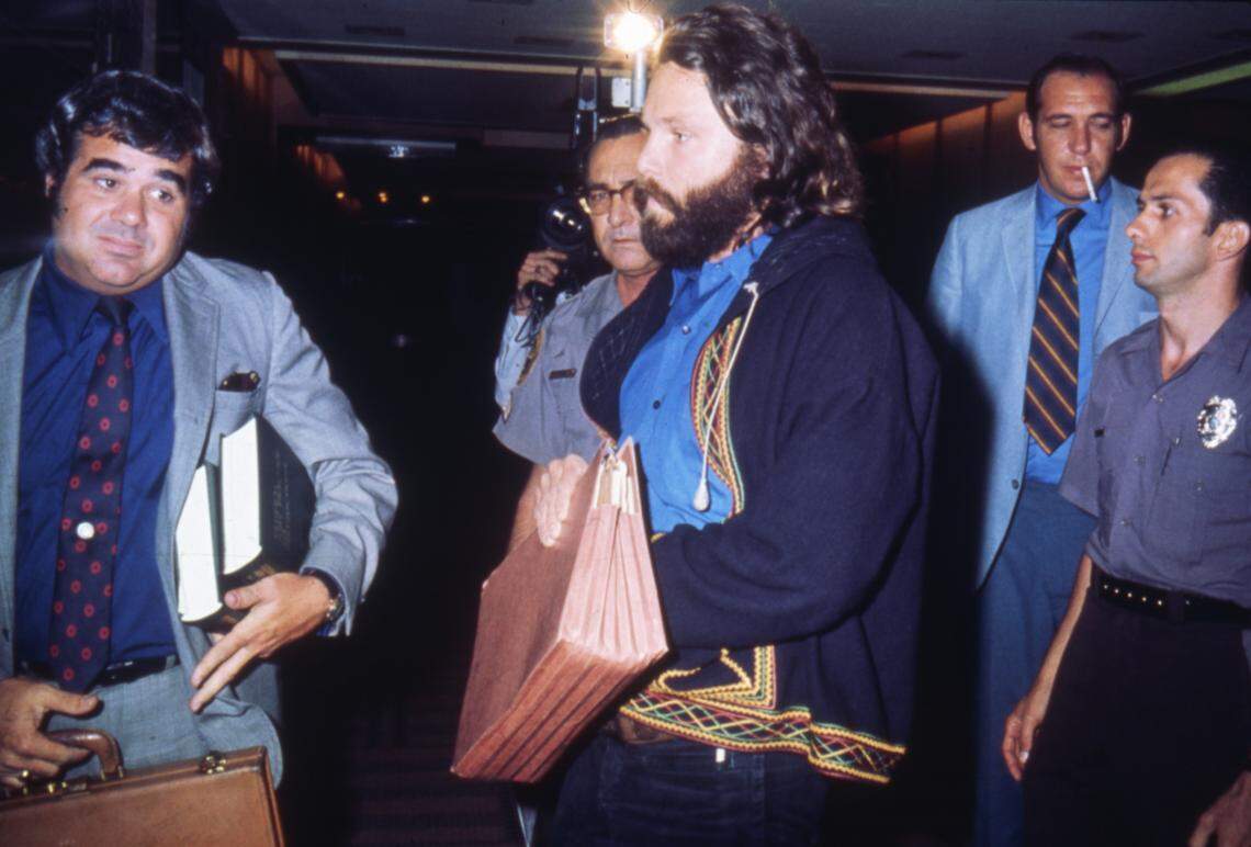Jim Morrison leaves courtroom with lawyers after his conviction on indecency charges stemming from March 1969 concert.
