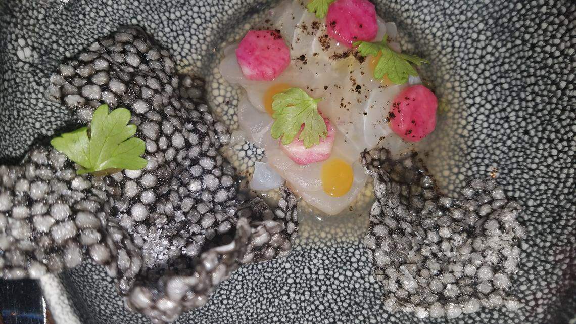 The snapper crudo appetizer with green tomato aguachile, black lime, maracuya and radish is an delicious edible work of art.