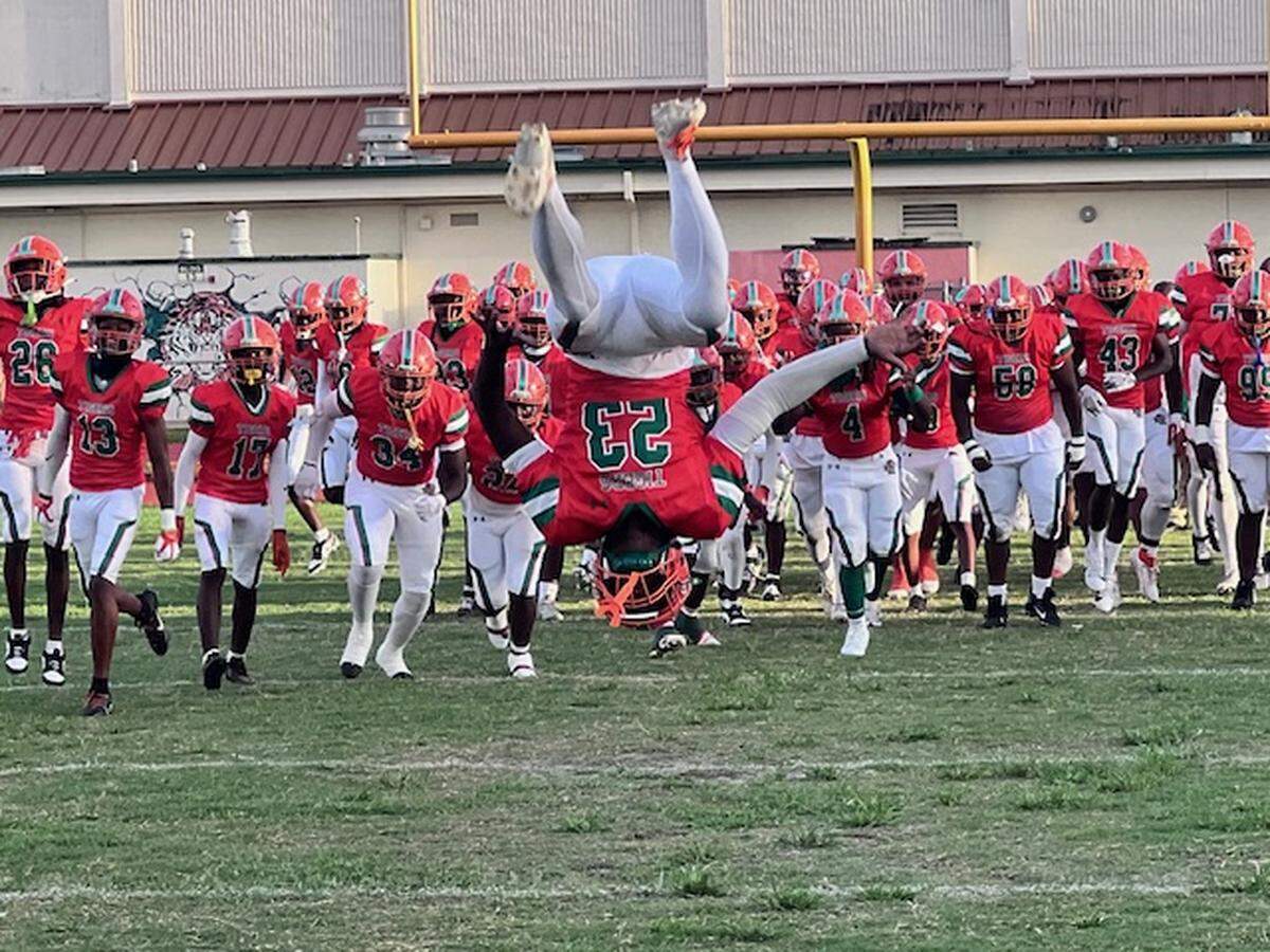 Blanche Ely junior running back Louis Kenson does a forward flip as his team enters the field prior to the opening kickoff of Friday’s game against Chaminade-Madonna. The Tigers beat the Lions 35-34 in overtime.