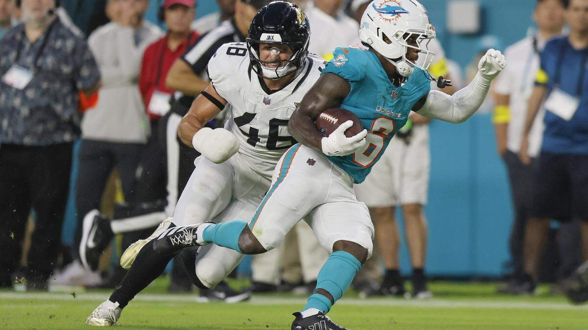 Miami Dolphins wide receiver Malik Washington (6) carries for a touchdown as Jacksonville Jaguars linebacker Chad Muma (48) gives chase in the first half during an NFL football game at Hard Rock Stadium in Miami Gardens, Florida, on Saturday, August 23, 2025.