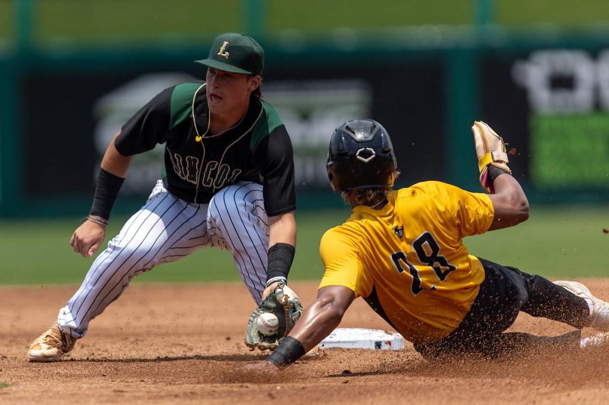 American Heritage base runner Lucas Ramirez (28) is tagged out at second by Tallahassee Lincoln second baseman Blair Baisden (15) during the Class 5A state semifinal game at Hammond Stadium on Friday, May 17, 2024, in Fort Myers, Fla.
