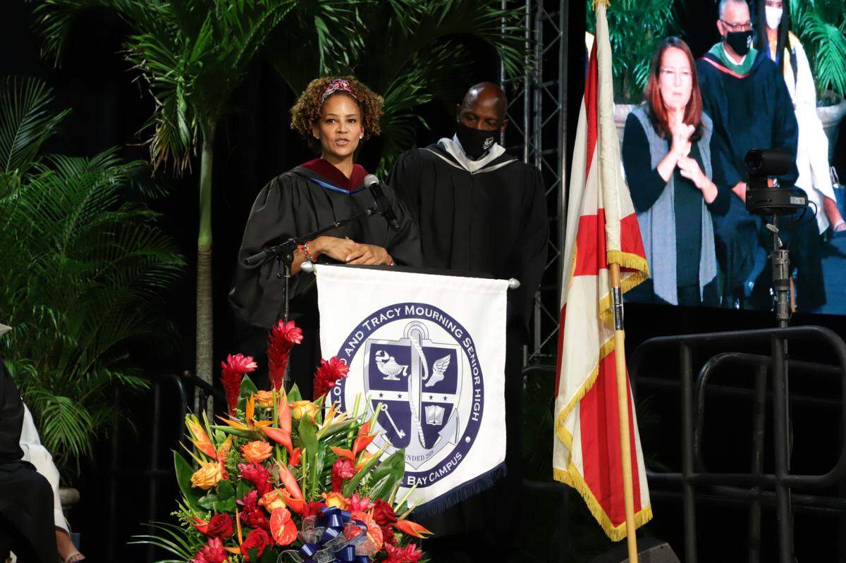 Tracy Mourning, with Alonzo Mourning looking on,&nbsp;addresses&nbsp;graduates of Alonzo and Tracy Mourning Senior High at&nbsp;the commencement&nbsp;ceremony held Tuesday, June 1, 2021, at the Ocean&nbsp;Bank Convocation Center at Florida&nbsp;International University’s main campus.&nbsp;