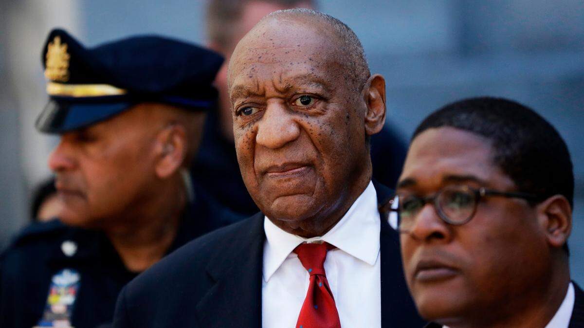 Bill Cosby, center, leaves the the Montgomery County Courthouse in Norristown, Pa. , in 2018. Pennsylvania’s highest court has overturned comedian Bill Cosby’s sex assault conviction. The court said Wednesday that they found an agreement with a previous prosecutor prevented him from being charged in the case.