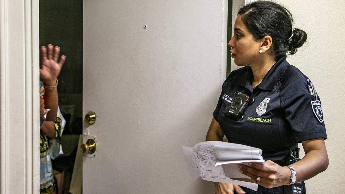 Miami Beach Code Compliance Officer Viji Maharaj speaks to a tourist staying at 1518 Drexel Avenue as she inspects for illegal short-term rentals in South Beach area on Saturday, February 23, 2019.