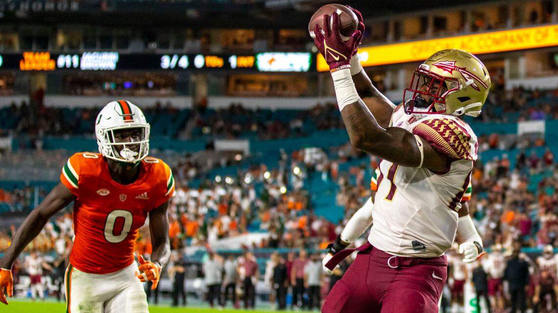 Florida State University tight end Camren McDonald (87) catches the touchdown pass while chased by Miami Hurricanes safety James Williams (0) during an ACC football game at Hard Rock Stadium in Miami Gardens on Saturday, November 5, 2022.