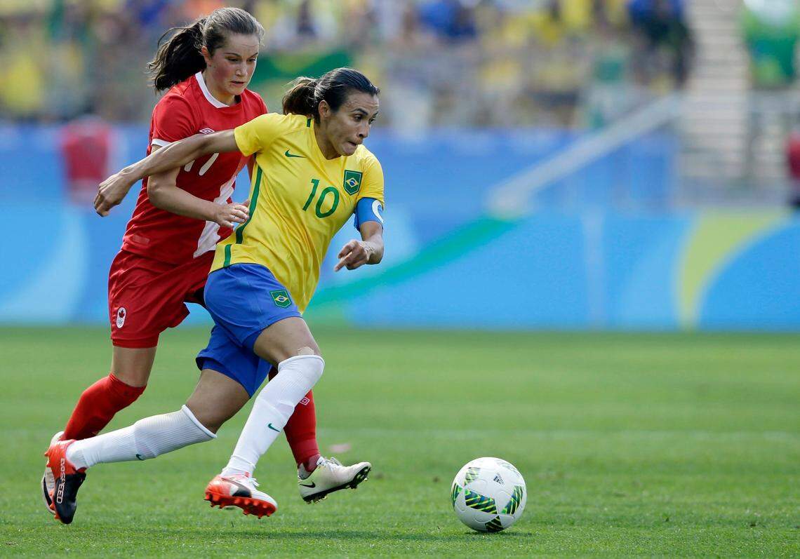 Brazil’s Marta, left, dribbles past Canada’s Jessie Fleming during the bronze medal women’ soccer match at the summer Olympic’s at the Arena Corinthians stadium in Sao Paulo.