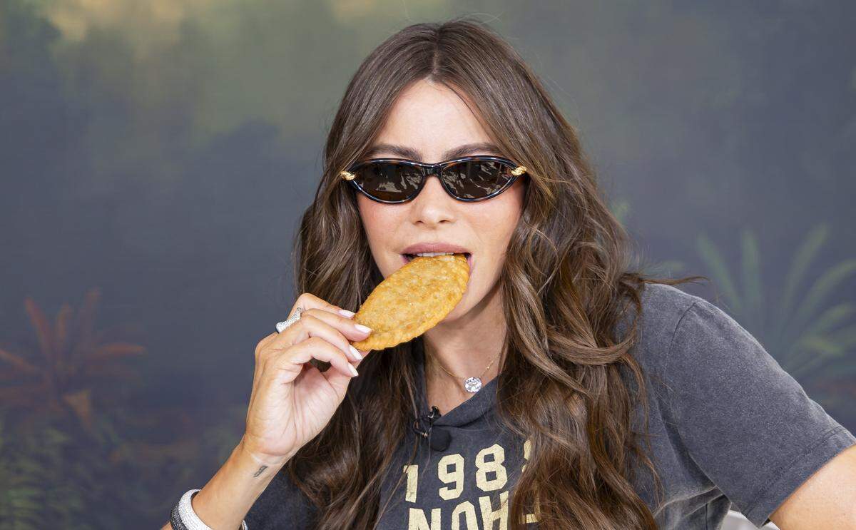 Colombian-American actress Sofía Vergara bites into a TOMA Empanada as she attends the Goya Foods' Grand Tasting Village during the Food Network South Beach Wine & Food Festival on Saturday, Feb. 21, 2026, in Miami Beach, Fla.