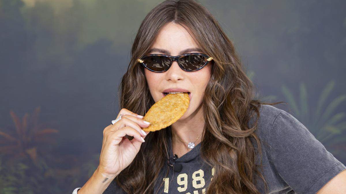 Colombian-American actress Sofía Vergara bites into a TOMA Empanada as she attends the Goya Foods' Grand Tasting Village during the Food Network South Beach Wine & Food Festival on Saturday, Feb. 21, 2026, in Miami Beach, Fla.